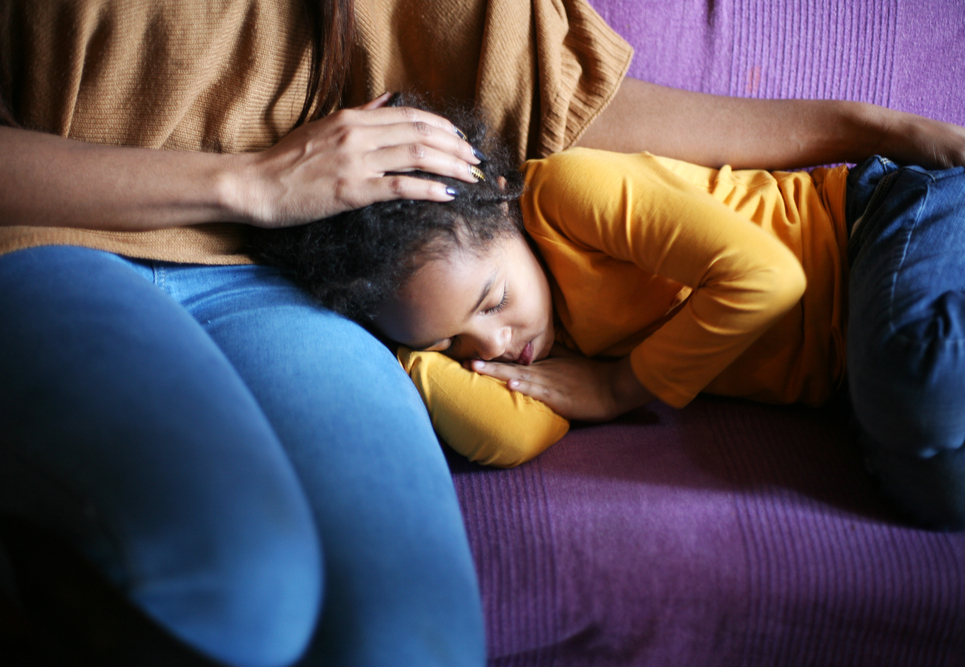 Little,African,American,Girl,Sleeping,In,Mother,Lap.